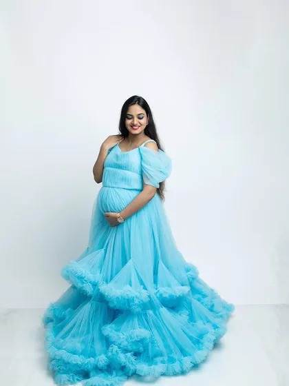 A candid, smiling moment from the blue gown maternity shoot. I always encourage natural expressions to capture the genuine happiness of this special time.