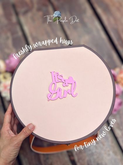 This round keepsake box, or hat box, is one of my favorite ways to package a gift. The simple "It's a Girl" tag makes for a clean, modern, and elegant presentation.