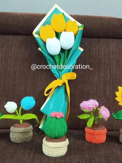 A display of some of our favorite creations, including potted sunflowers, a cactus, a tulip bouquet, and other mini potted flowers. This shows the variety we offer.