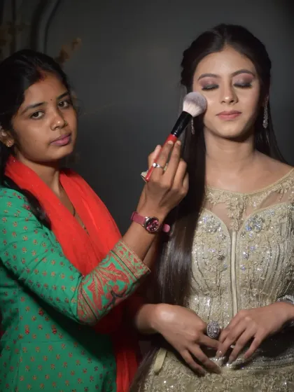 Practice makes perfect. This student is working on a subtle party makeup look, learning how to blend eyeshadow and apply a base for a flawless finish under different lighting conditions.