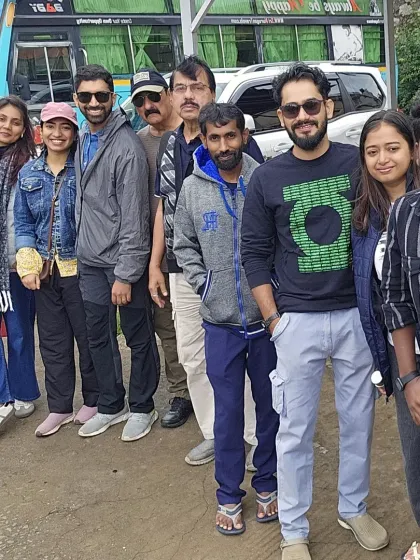 Our group posing by the bus during a break. The journey to and from the trek location is an integral part of the experience.