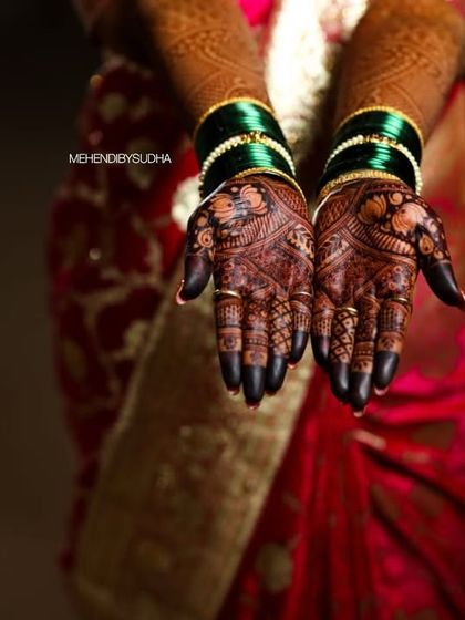 A professional shot capturing the deep, dark stain on a bride's palms during her wedding ceremony.