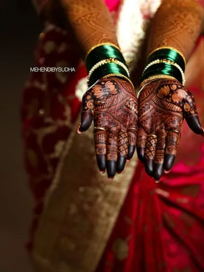 A professional shot capturing the deep, dark stain on a bride's palms during her wedding ceremony.
