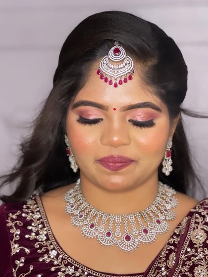 A detailed shot of the eye makeup, featuring a beautiful blend of pink and silver shimmer that makes her eyes sparkle.