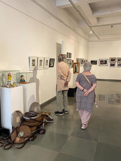 Balan Nambiar and his companion exploring the various displays, including film reels and other cinematic artifacts.