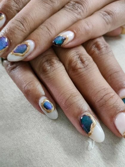 A unique and artistic geode-inspired design, with blue and purple crystal patterns outlined in gold on a solid white base.