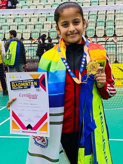 A young Delhi State Champion proudly holds her gold medal and certificate. We aim to build a strong foundation that enables our players to excel in state-level competitions from an early age.