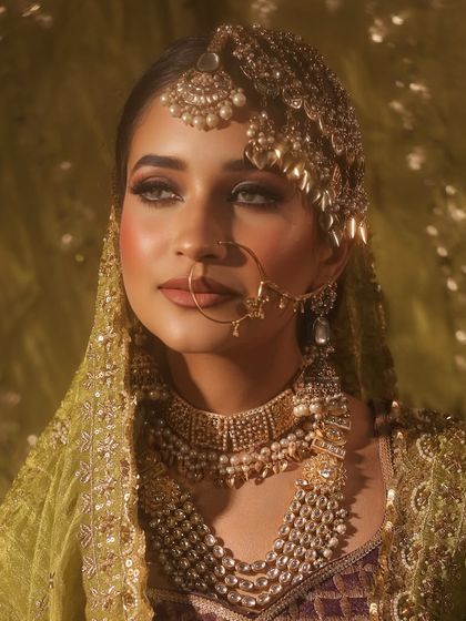 A close-up on the face of this regal bride. Notice the perfectly blended eyeshadow and the soft, radiant glow on her skin.