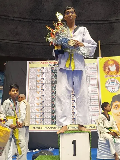 Another first-place winner from Team ASHA, holding his trophy and flowers at the national championship.