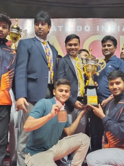 The team celebrating with the trophy at the India Open International Karate Championship. A result of collective hard work.