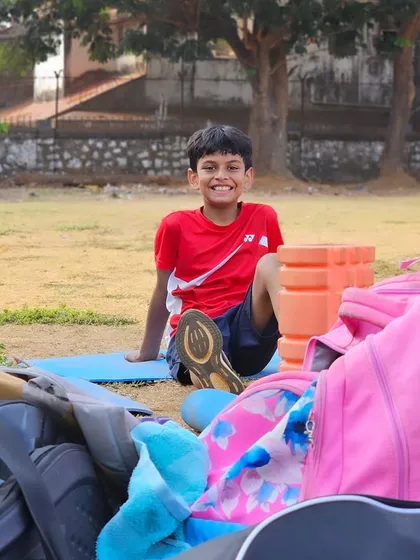 A young player takes a well-deserved rest amidst the equipment after a challenging fitness session.