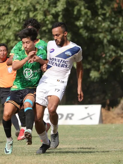 An intense on-field battle during a match. Our players are trained to be physically strong and fight for every ball.