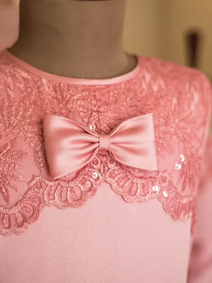 The details are where the magic happens. This close-up shows the intricate lace work and delicate sequins I use on a bodice, finished with a perfectly tied satin bow to complete the look.