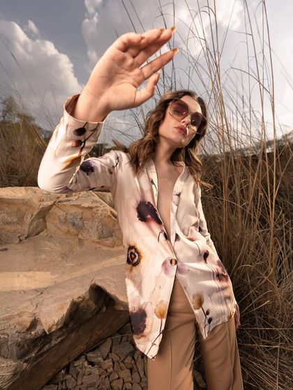 A dynamic pose where the model interacts with the sunlight. This technique creates interesting shadows and highlights, adding an artistic flair to the fashion photograph.