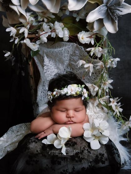 An angel in white. The monochromatic white floral theme, with a mix of textures from lace and flowers, creates a portrait of pure elegance and innocence.