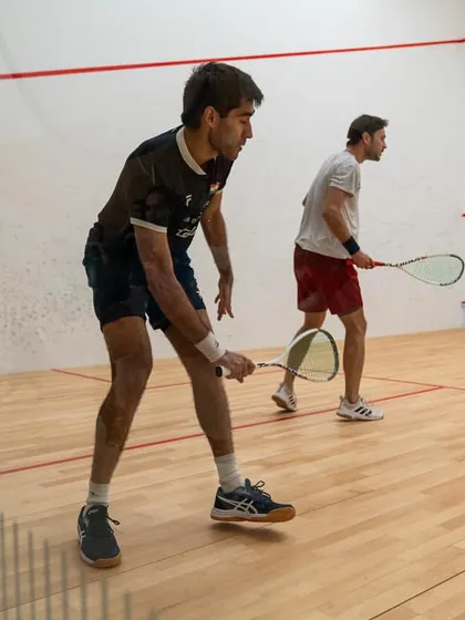 Ramit Tandon in action during a professional PSA tour match. This image captures the focus and intensity required to compete at the highest level of international squash.