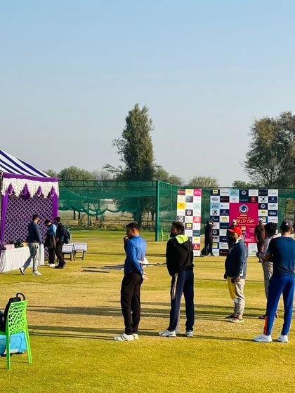Players and organizers gather during a break in the Corporate Ka World Cup. We ensure there are proper arrangements with tents and seating for a comfortable tournament experience.