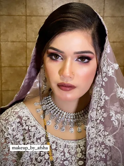 A close-up of a dramatic, smokey eye look with a bold, glittery lid.