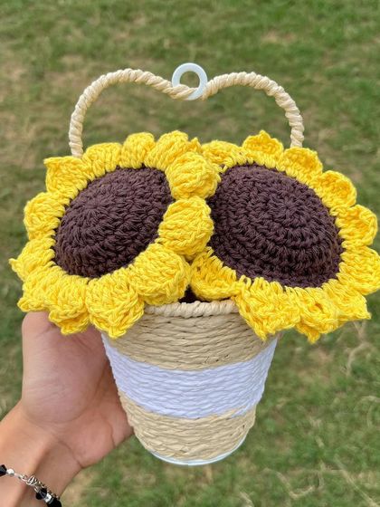 Another view of the crochet sunflower basket, showing the heart-shaped handle that allows it to be hung as a unique piece of wall decor.