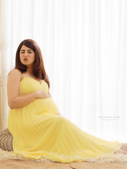 We love capturing playful and candid moments too. This fun expression shows the lighter side of pregnancy and makes for a memorable, authentic photo.