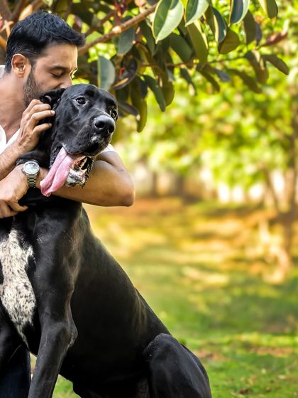 A tender moment as a dog dad gives his Great Dane a loving hug. These are the unposed, heartfelt moments I strive to capture.