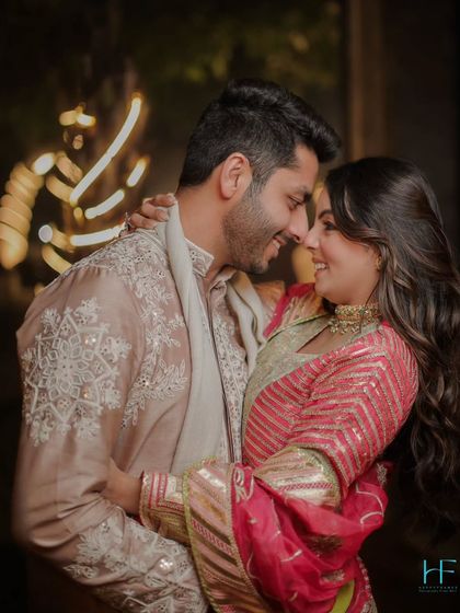 The couple looks into each other's eyes, their smiles reflecting their deep affection in this romantic, warmly lit portrait.