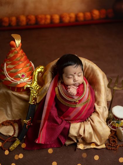 A slightly different composition of the Jijabai theme, focusing on the baby's serene pose with hands gently clasped.