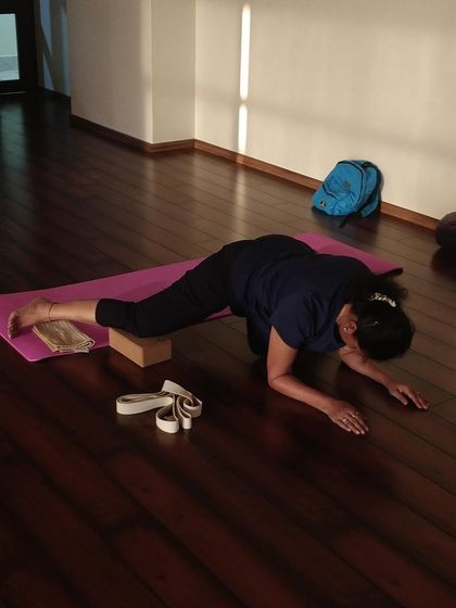 Using a yoga block and strap to work on hip and hamstring flexibility. Simple props can be incredibly effective for releasing tension and finding more ease.