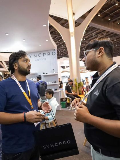 We believe in providing one-on-one attention to understand each person's unique needs. A team member is captured here listening to a visitor's requirements at our expo booth.