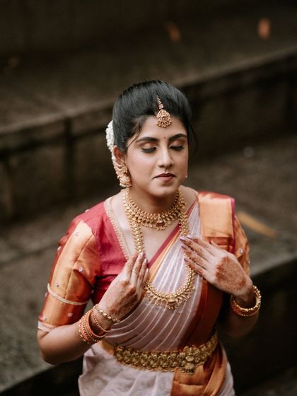 A close-up of the bride, capturing the intricate details of her traditional jewelry and the serene expression on her face during her engagement.