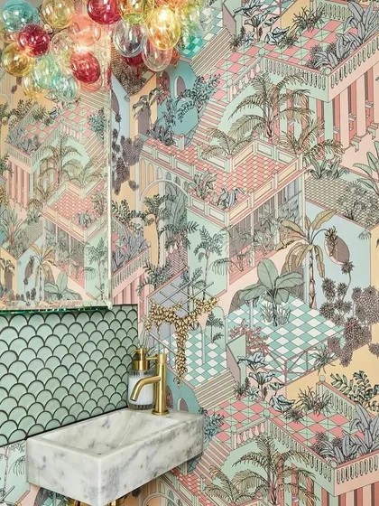 A tribute to tropical grandeur, the 'Miami' wallpaper from Cole & Son features joyful tiers of terraced colonnades in a pastel palette. This design creates a kaleidoscope of architectural and botanical exuberance in this stylish powder room.