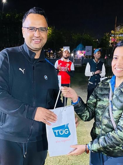 A player from the winning team receives her prize. We ensure that every member of the champion squad is recognized for their contribution.