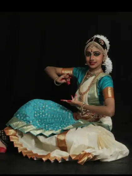 This is Visakha, pictured before her Arangetram. The traditional temple jewelry and silk saree are essential elements of the Bharatanatyam costume, completing the dancer's transformation.