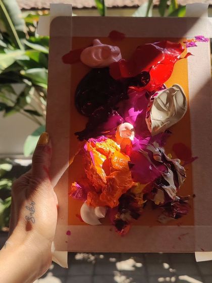 A glimpse into the material process, showing a palette of thick, vibrant acrylic paints ready to be applied, representing the start of a colorful creation.