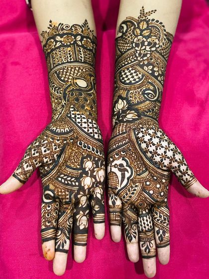 This traditional design is filled with classic elements, including parrots, paisleys, and checkerboard patterns, creating a rich and full look for the bride.