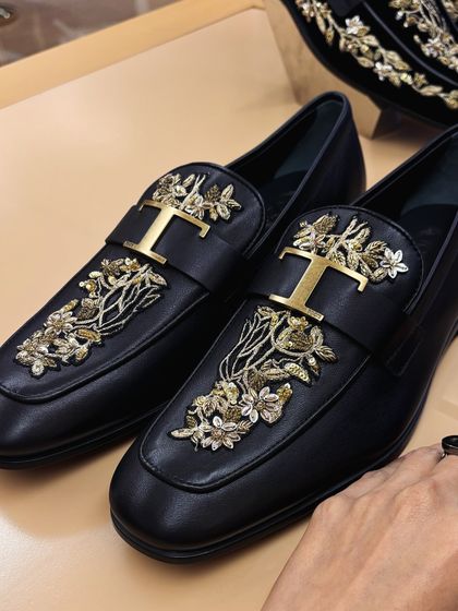 A close-up of the embroidered loafers from the collection. The detail is exquisite.