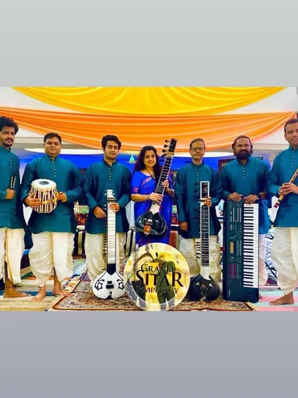 My complete ensemble, the Grand Sitar Symphony. We combine traditional instruments like the sitar and tabla with modern ones like the electric sitar and keyboard.