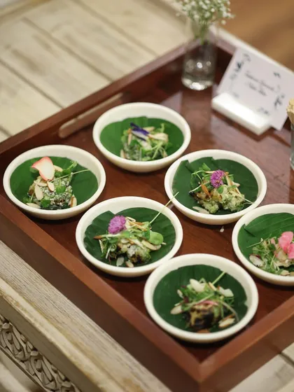 A tray of assorted canapés served on fresh banana leaves. The natural presentation adds an earthy and authentic touch to our modern culinary creations.