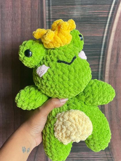 A frog prince, complete with a little yellow crown. This super soft and cuddly plushie was made with chenille yarn, making him extra huggable.