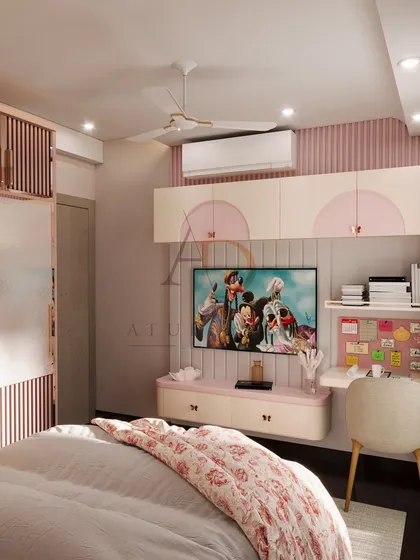 A close-up of the TV and study area in a princess-themed room, featuring playful pink accents and practical, floating storage.