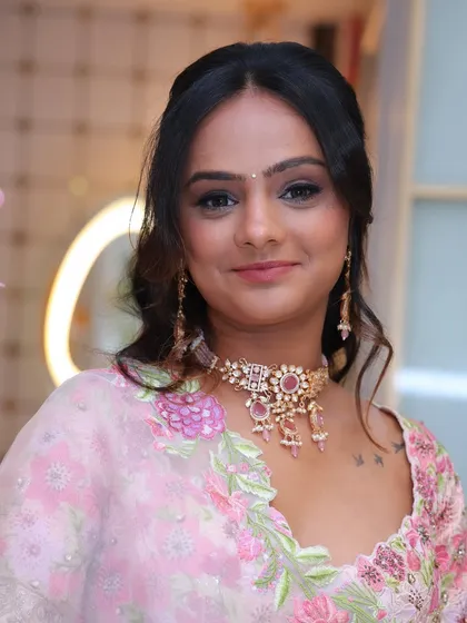 A portrait of the happy client, showcasing her complete engagement look with glowing skin and a perfectly coordinated pink-toned makeup palette.