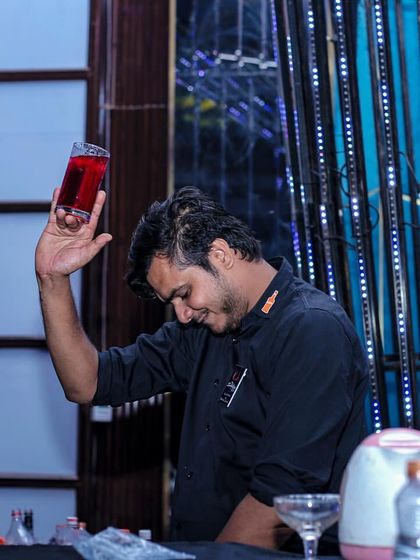 Another angle of my flair bartender, capturing the dynamic movement and skill involved in his craft. It’s this level of showmanship that sets my service apart.