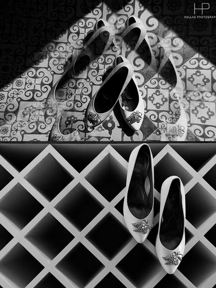 An artistic detail shot of the bride's and bridesmaids' shoes, playing with light, shadow, and patterns.