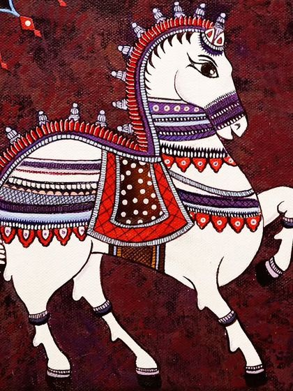 Another version of the decorated Indian horse, this time against a deep red background, highlighting the versatility of folk art motifs.