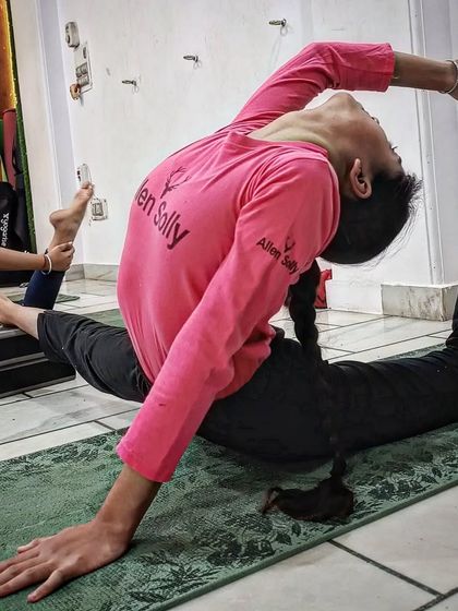 A young student demonstrates remarkable flexibility in this advanced backbending asana.