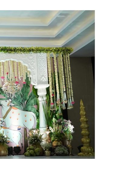 Another corner of the Pichwai stage, focusing on the Nandi art and the blend of traditional brassware with fresh flowers and banana leaves.