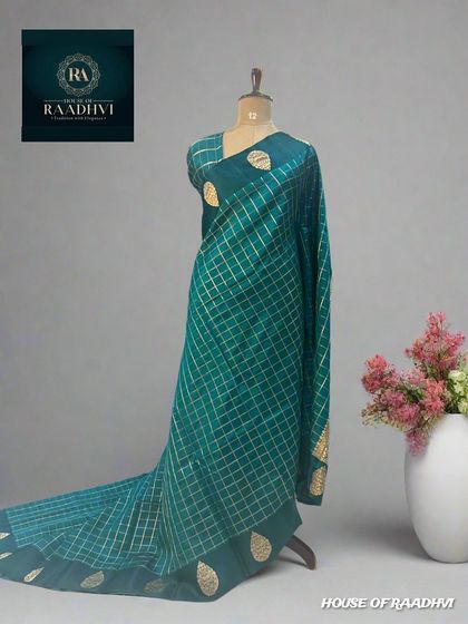 The same checks pattern pure Banaras lightweight silk saree in a lovely teal green.