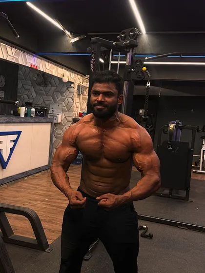 A front double bicep pose from one of my athletes, showing impressive size and definition.