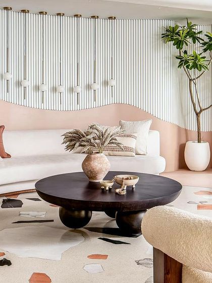 The living room of the "Marshmallow" penthouse, where soft curves, a marshmallow-hued palette, and luxurious textures create a whimsical and sophisticated space.