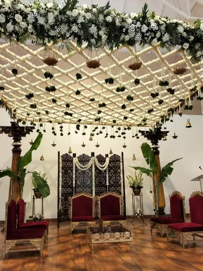 This traditional South Indian mandap showcases our expertise in intricate floral work. We created a stunning overhead lattice of fresh jasmine and tuberose, accented with hanging temple bells and banana leaf pillars, to craft a sacred and elegant ceremony space.